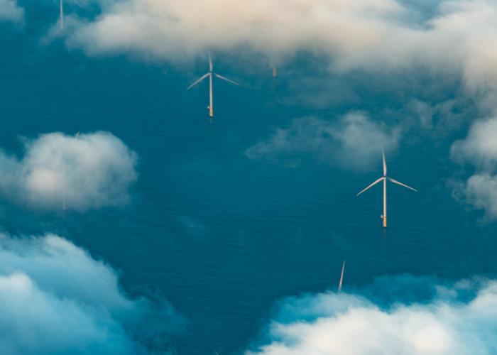 Aerial view of wind farm in sea with white clouds