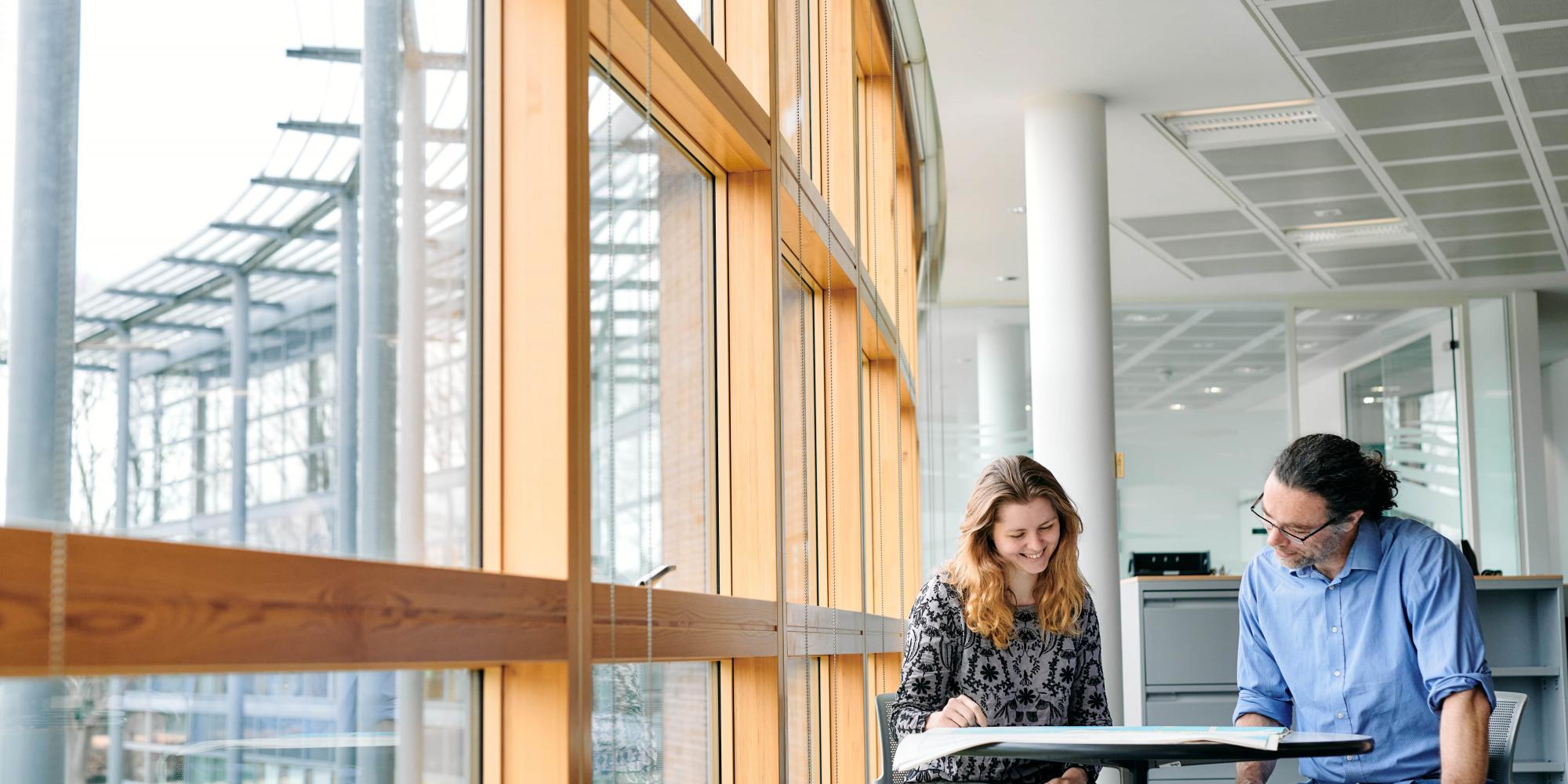 Two people sitting at desk