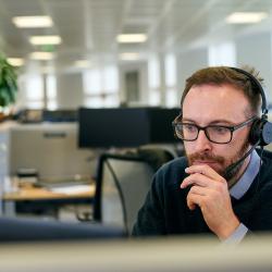 Scientist Connor McCarron sitting at his desk